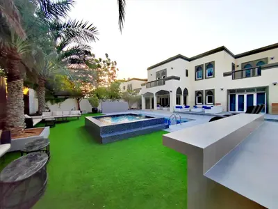 an exterior view of a house with a swimming pool at Royal Palazzo with private Pool and BBQ on Marina, huge 7Bedroom Villa in Dubai