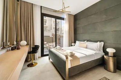 a bedroom with a large bed and a balcony at Chic and Peaceful Studio with Balcony & Pool in JVC in Dubai