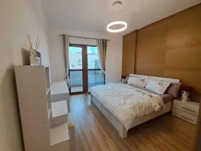 a bedroom with a white bed and a window at Modern One-Bedroom Apartment King and Queen Beds Two Bathrooms in Dubai
