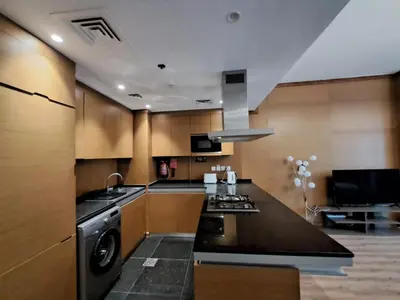 a kitchen with a sink and a stove top oven at Modern One-Bedroom Apartment King and Queen Beds Two Bathrooms in Dubai