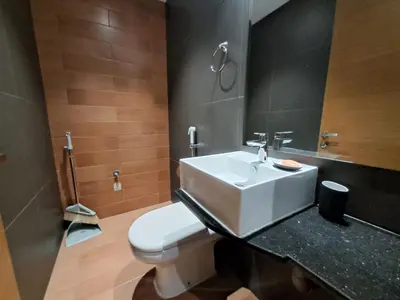 a bathroom with a white sink and a toilet at Modern One-Bedroom Apartment King and Queen Beds Two Bathrooms in Dubai