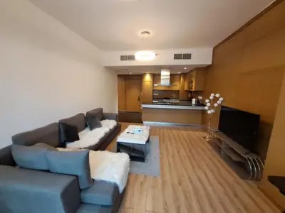 a living room with a couch and a table at Modern One-Bedroom Apartment King and Queen Beds Two Bathrooms in Dubai