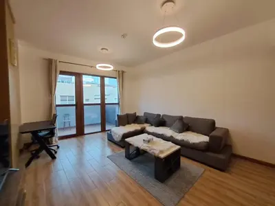 a living room with a couch and a table at Modern One-Bedroom Apartment King and Queen Beds Two Bathrooms in Dubai