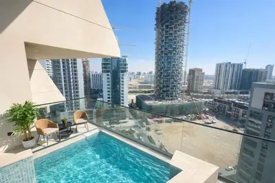 a balcony with a swimming pool on top of a building at Tranquil 1BR with Private Plunge Pool in Dubai