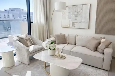 a living room with a couch and a table at Tranquil 1BR with Private Plunge Pool in Dubai