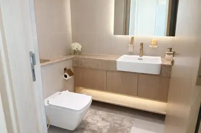 a bathroom with a white toilet and a sink at Tranquil 1BR with Private Plunge Pool in Dubai