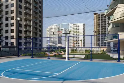 a tennis court in the middle of a city at Tranquil 1BR with Private Plunge Pool in Dubai