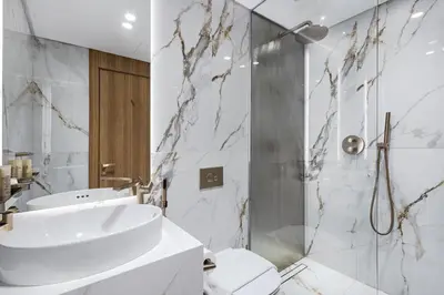 a white bathroom with a sink and a shower at Jasmine Lane, JGE - 3 Bedroom with maids' room Townhouse - Allsopp & Allsopp in Dubai
