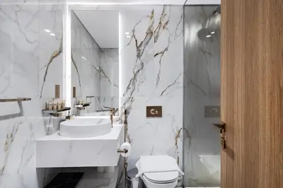 a white bathroom with a sink and a toilet at Jasmine Lane, JGE - 3 Bedroom with maids' room Townhouse - Allsopp & Allsopp in Dubai