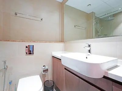 a bathroom with a white sink and a toilet at Bright & Spacious 2-Bedroom Apartment Al furjan-706 in Dubai