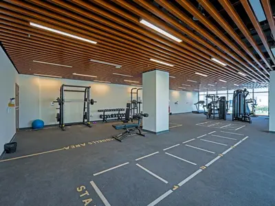 a gym with lots of equipment in a building at Bright & Spacious 2-Bedroom Apartment Al furjan-706 in Dubai