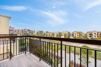 a balcony with a view of a city at Daniels 3BR Villa plus M at La Mer With Beach Access in Dubai