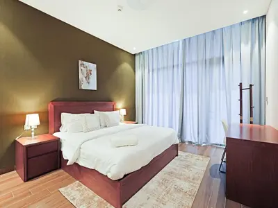 a bedroom with a large bed and a desk at Comfortable 2-Bedroom Home in Al Furjan-607 in Dubai
