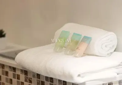 a stack of towels sitting on top of a counter at Luxury Apt Canal View - 5min Burj & Dubai Mall in Dubai