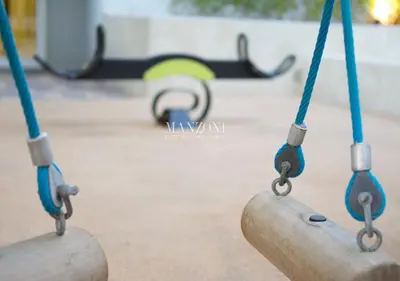 two swings in a playground with a skateboard in the background at Luxury Apt Canal View - 5min Burj & Dubai Mall in Dubai