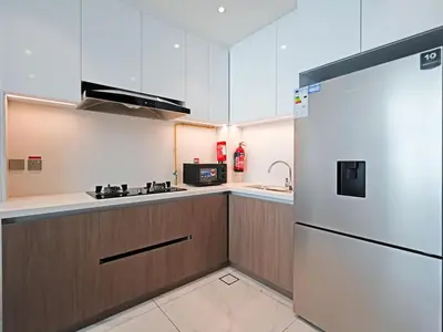 a kitchen with a refrigerator and a sink at Elegant 1-Bedroom Apartment in Al Furjan-G01 in Dubai