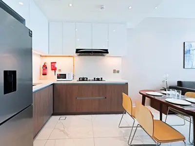 a kitchen and dining room with a table and chairs at Modern 1-Bedroom Apartment in Sepcoo Residence-1005 in Dubai