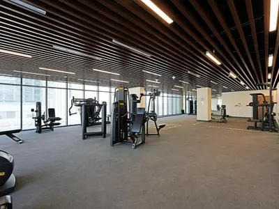 a gym with treadmills and exercise equipment in a building at Modern 1-Bedroom Apartment in Sepcoo Residence-1005 in Dubai