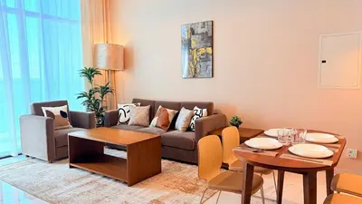 a living room with a couch and a table at Ready-to-Move 1-Bedroom in Al Furjan-103 in Dubai