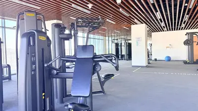 a gym with a treadmill and a bike at Ready-to-Move 1-Bedroom in Al Furjan-103 in Dubai