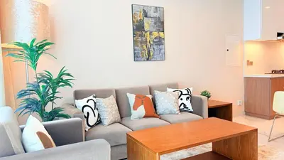 a living room with a couch with pillows on it at Ready-to-Move 1-Bedroom in Al Furjan-103 in Dubai