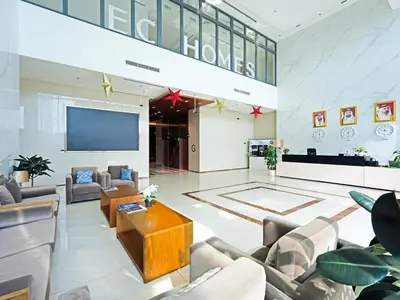 a lobby with couches and a flat screen tv at Spacious 2-Bedroom Apartment Al Furjan-104 in Dubai
