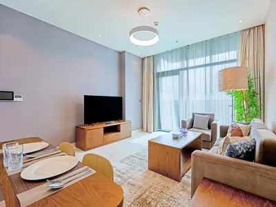 a living room with a couch and a tv at Spacious 2-Bedroom Apartment Al Furjan-104 in Dubai