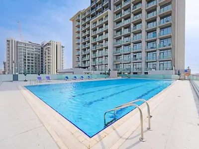 a large swimming pool in front of a building at Spacious 2-Bedroom Apartment Al Furjan-104 in Dubai