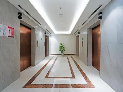 a corridor of an office building with a potted plant at Spacious 2-Bedroom Apartment in Al Furjan-1010 in Dubai