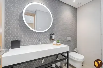 a bathroom with a sink and a mirror and a toilet at Vogue JVT Novotel Near Springs Souk Mall, One Bedroom Apartment with Large Balcony and Vibrant Community view, Access to all Amenities in Dubai