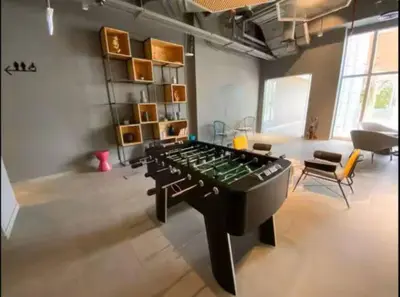 a living room with a large chess board in the middle at Vogue JVT Novotel Near Springs Souk Mall, One Bedroom Apartment with Large Balcony and Vibrant Community view, Access to all Amenities in Dubai
