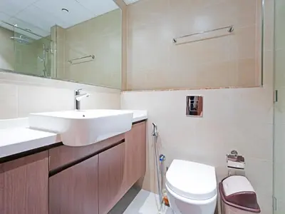 a bathroom with a sink and a toilet and a mirror at Well-Maintained 2-Bedroom Apartment Al Furjan-207 in Dubai