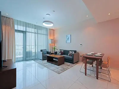a living room with a couch and a table at Well-Maintained 2-Bedroom Home in Community-410 in Dubai
