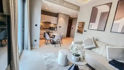 a living room with a white couch and a table at STAY BY LATINEM Luxury 1BR Holiday Home CVR A 1410 near Downtown in Dubai
