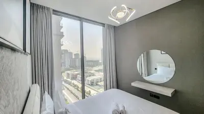 a bedroom with a mirror and a large window at STAY BY LATINEM Luxury 1BR Holiday Home CVR A 1410 near Downtown in Dubai