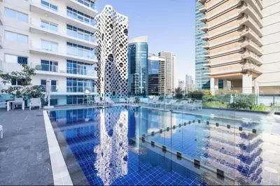 a large swimming pool in a city with buildings at Extra-Large Studio l AG Tower l Business Bay in Dubai