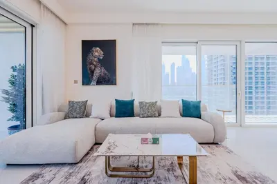 a living room with a couch and a painting of a dog at TRPS - Grand Bleu Tower 2, EMAAR Beachfront - Atlantis & Marina View, Private Beach, Furnished in Dubai