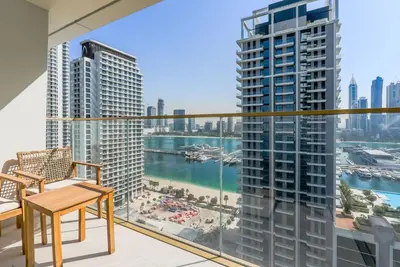 a balcony with a view of the water and buildings at TRPS - Grand Bleu Tower 2, EMAAR Beachfront - Atlantis & Marina View, Private Beach, Furnished in Dubai