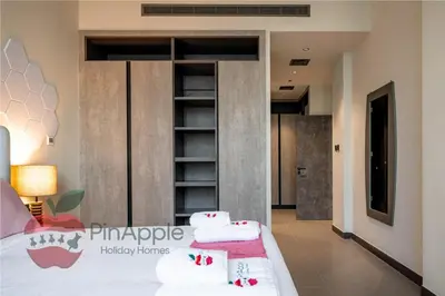 a bedroom with a bed with towels on it at High Floor With Full Lake View in Dubai