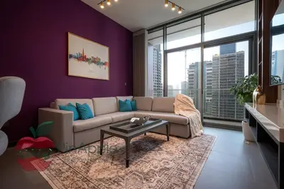 a living room with purple walls and a couch at High Floor With Full Lake View in Dubai