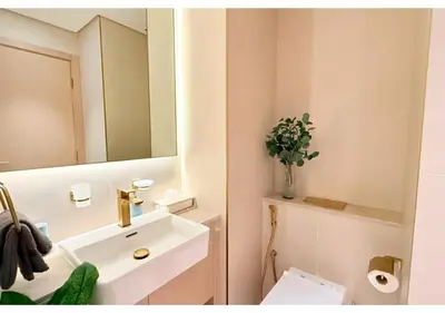 a bathroom with a white sink and a mirror at Chic Modern Studio Unit in JVC with 65 inch TV in Dubai