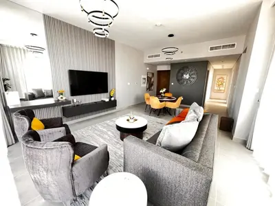 a living room with two couches and a tv at Brand New & Welcoming 2BDR In Forte Downtown 34 in Dubai