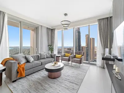 a living room with a couch and chairs and large windows at Brand New & Welcoming 2BDR In Forte Downtown 34 in Dubai