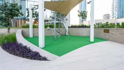 a playground in a building with green grass at Brand New & Welcoming 2BDR In Forte Downtown 34 in Dubai