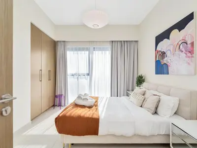 a white bedroom with a large bed and a window at Burj Royale Collection by The Luxe Manor - Downtown Dubai in Dubai