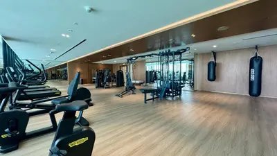 a gym with treadmills and exercise equipment in a building at Amazing Studio with Balcony and Jacuzzi I Near Dubai Mall & Downtown I Sleeps 4 in Dubai