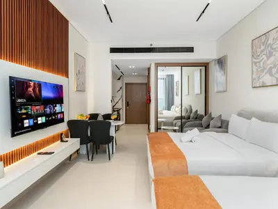 a bedroom with a bed and a living room at Amazing Studio with Balcony and Jacuzzi I Near Dubai Mall & Downtown I Sleeps 4 in Dubai