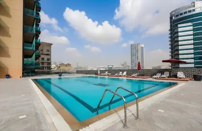 a swimming pool on the roof of a building at The Eden Suite Modern Luxury Meets Cozy Comfort in Dubai