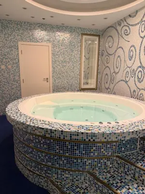 a bathroom with a large tub in a room at Fully Luxury Studio Total Privacy Pool & Sauna in Dubai