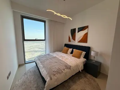 a bedroom with a bed and a large window at 17 Icon Bay Creek Harbour in Dubai